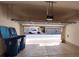 Open garage with view to the street and garbage cans in the corner at 8664 Traveling Breeze Ave # 102, Las Vegas, NV 89178