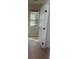 Tiled hallway with a full door on hinges at 8664 Traveling Breeze Ave # 102, Las Vegas, NV 89178