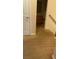 Carpeted hallway leading to a bathroom and staircase, with a door providing access to another room at 8664 Traveling Breeze Ave # 102, Las Vegas, NV 89178