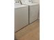 Tile laundry room with a white washer and dryer at 8664 Traveling Breeze Ave # 102, Las Vegas, NV 89178
