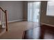 Open-concept living area with staircase, sliding door, and tile floors at 8664 Traveling Breeze Ave # 102, Las Vegas, NV 89178