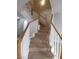Carpeted staircase featuring a white railing with wood trim leads to the upper level at 8664 Traveling Breeze Ave # 102, Las Vegas, NV 89178