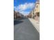 Street featuring attached two-story homes at 8664 Traveling Breeze Ave # 102, Las Vegas, NV 89178