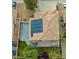 Aerial view of a home featuring solar panels on the tile roof and a lush green lawn at 8980 Tumbling Pebble Way, Las Vegas, NV 89123