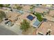 Aerial view highlighting solar panels, lush landscaping, and a residential pool at 8980 Tumbling Pebble Way, Las Vegas, NV 89123