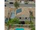 Aerial perspective of home showcasing solar panels, landscaped backyard, and in-ground pool at 8980 Tumbling Pebble Way, Las Vegas, NV 89123