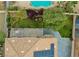 Backyard featuring a pool, manicured lawn, patio area, and mature landscaping at 8980 Tumbling Pebble Way, Las Vegas, NV 89123