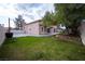 Expansive backyard with green grass, patio space, and landscaping, perfect for outdoor living at 8980 Tumbling Pebble Way, Las Vegas, NV 89123