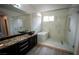 Modern bathroom featuring a vessel sink, glass shower, and soaking tub with stone tile accents at 8980 Tumbling Pebble Way, Las Vegas, NV 89123