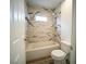 Modern bathroom with tiled tub and shower at 8980 Tumbling Pebble Way, Las Vegas, NV 89123