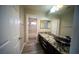 Bathroom with long granite countertop, modern vessel sink, and doorway view of tub/shower at 8980 Tumbling Pebble Way, Las Vegas, NV 89123
