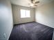 Comfortable bedroom with a ceiling fan and soft carpeting at 8980 Tumbling Pebble Way, Las Vegas, NV 89123