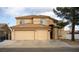 Charming two-story stucco home featuring a tile roof and a spacious three-car garage at 8980 Tumbling Pebble Way, Las Vegas, NV 89123
