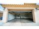 Spacious three-car garage with an automatic door opener, ready to accommodate vehicles and storage at 8980 Tumbling Pebble Way, Las Vegas, NV 89123