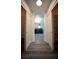 Hallway between closets showing the bathroom with dark cabinets and a modern glass shower at 8980 Tumbling Pebble Way, Las Vegas, NV 89123
