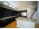 Spacious kitchen featuring dark cabinetry, granite countertops, a central island, and stainless steel appliances, perfect for cooking at 8980 Tumbling Pebble Way, Las Vegas, NV 89123