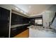 Modern kitchen with dark cabinets, granite countertops, a large island, and stainless steel appliances, stylish and functional at 8980 Tumbling Pebble Way, Las Vegas, NV 89123