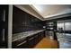 Modern kitchen featuring granite countertops, stainless steel appliances, and sleek black cabinetry at 8980 Tumbling Pebble Way, Las Vegas, NV 89123