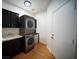 Convenient laundry room with stacked washer/dryer and utility sink at 8980 Tumbling Pebble Way, Las Vegas, NV 89123