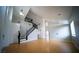 A spacious living room with hardwood floors, high ceilings, and a staircase at 8980 Tumbling Pebble Way, Las Vegas, NV 89123