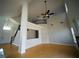 Spacious living room featuring tall ceilings, wood flooring, and a staircase leading to the second level at 8980 Tumbling Pebble Way, Las Vegas, NV 89123