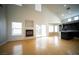 A large living room with hardwood floors, fireplace, and open access to the kitchen at 8980 Tumbling Pebble Way, Las Vegas, NV 89123