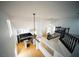 Open-concept living space with a view of the kitchen, staircase, and loft area with wood flooring at 8980 Tumbling Pebble Way, Las Vegas, NV 89123