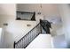 Staircase with dark railings leading to the second floor at 8980 Tumbling Pebble Way, Las Vegas, NV 89123