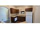 Kitchen featuring granite countertops, white appliances, dark cabinets, and stainless steel double sink at 9000 Las Vegas Blvd # 1015, Las Vegas, NV 89123
