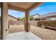 Serene backyard featuring a covered patio and well-maintained gravel landscaping at 9049 Teetering Rock Ave, Las Vegas, NV 89143