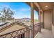 Balcony with wrought iron railing featuring neighborhood and mountain views at 9049 Teetering Rock Ave, Las Vegas, NV 89143
