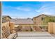 Relaxing balcony view of neighboring homes, featuring clear blue skies and a comfortable outdoor seating area at 9049 Teetering Rock Ave, Las Vegas, NV 89143