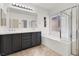 Bright bathroom featuring a double vanity, soaking tub, and walk-in shower, perfect for relaxation at 9049 Teetering Rock Ave, Las Vegas, NV 89143