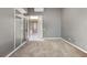 Bedroom with carpeted floors, a light gray color scheme, and sliding glass doors leading to the home entrance at 9049 Teetering Rock Ave, Las Vegas, NV 89143