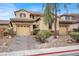 Charming two-story home featuring a dual garage, desert landscaping, and a welcoming facade with neutral color palette at 9049 Teetering Rock Ave, Las Vegas, NV 89143