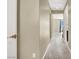 Bright hallway featuring neutral walls, white trim, and plush carpet for easy navigation through the home at 9049 Teetering Rock Ave, Las Vegas, NV 89143