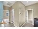 Bright hallway featuring neutral walls, white trim, and multiple doorways for easy navigation through the home at 9049 Teetering Rock Ave, Las Vegas, NV 89143