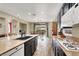 Kitchen featuring a large island with sink, granite countertops, and gas range at 9049 Teetering Rock Ave, Las Vegas, NV 89143
