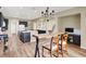 Spacious open-concept kitchen and dining area with modern decor and wood-look flooring at 9049 Teetering Rock Ave, Las Vegas, NV 89143