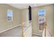 Upstairs landing with carpet and multiple windows for ample natural light at 9049 Teetering Rock Ave, Las Vegas, NV 89143