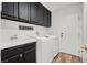 Laundry room with sink, cabinets, and washer/dryer at 9049 Teetering Rock Ave, Las Vegas, NV 89143
