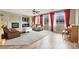 Open-concept living room featuring a fireplace, hardwood floors, and an abundance of natural light, creating a warm and inviting atmosphere at 9049 Teetering Rock Ave, Las Vegas, NV 89143