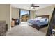 Comfortable main bedroom featuring a ceiling fan and access to a private balcony for relaxation and outdoor enjoyment at 9049 Teetering Rock Ave, Las Vegas, NV 89143