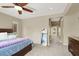 Cozy main bedroom featuring soft carpet, ceiling fan, and ensuite bathroom entrance, promoting relaxation at 9049 Teetering Rock Ave, Las Vegas, NV 89143