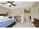 Comfortable main bedroom featuring a ceiling fan, carpeted floor, and access to the bathroom and closet at 9049 Teetering Rock Ave, Las Vegas, NV 89143
