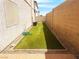 A low-maintenance backyard featuring artificial grass, offering a clean and green outdoor space at 9073 Spoonbill Ridge Pl, Las Vegas, NV 89143