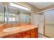 Bright bathroom features a shower/tub, wooden vanity and large mirror perfect for getting ready at 9073 Spoonbill Ridge Pl, Las Vegas, NV 89143