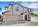 Two-story home featuring stucco siding, a two-car garage, and a well-manicured front yard at 9073 Spoonbill Ridge Pl, Las Vegas, NV 89143