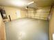 Spacious garage with a white door, painted floor, and neutral walls, ready for your vehicles and storage needs at 9073 Spoonbill Ridge Pl, Las Vegas, NV 89143