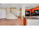 Open-concept kitchen with dark appliances and granite countertops, adjacent to a staircase and entry door at 9073 Spoonbill Ridge Pl, Las Vegas, NV 89143